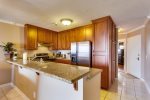 Lovely Cherry hardwood cabinets contain everything you need for cooking and dining at home. 